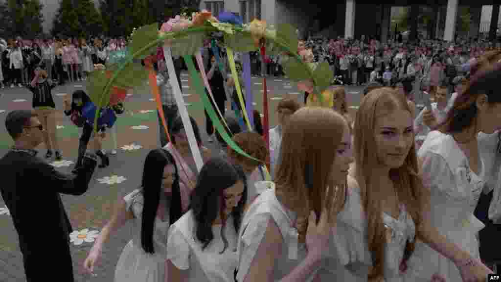 „Mint minden anya, én is aggódom a gyermekem jövője miatt. Iskolásként nagyobb biztonságban volt. A felnőtt élet nehezebb lesz a számára most, hogy háború van” – mondta egy érettségiző diák édesanyja az AFP-nek. A képen gimnazisták ballagnak Kijevben május 30-án