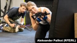 A woman and man take part in a training session at the EBSH sports club in Kyiv.