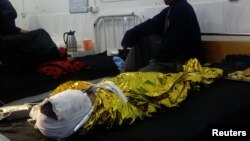 An Afghan boy receives treatment at a hospital after an airstrike in the southern province of Helmand on November 28.