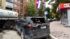 KOSOVO -- Damaged cars are pictured following clashes with ethnic Serbs during a police operation against the smuggling of goods, in Mitrovica, Kosovo, October 13, 2021. 