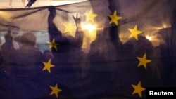 Ljudi drže veliku zastavu EU tokom mitinga podrške članstvu Poljske u Evropskoj uniji nakon što je Ustavni sud zemlje donio odluku o primatu ustava nad zakonima EU, potkopavajući ključno načelo evropskih integracija, u Lublinu, Poljska, 10. oktobra, 2021.