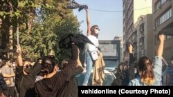 Women protest on the streets of Tehran on December 8.