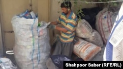 Former Afghan special forces commander Sayed Ahmad Nouri collecting garbage in Iran.