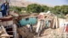 Afghanistan - Afghan earthquake survivors search through the remains of a damaged house at a village in Tashqurghan, in the Khulm district of Samangan province on November 3, 2025.