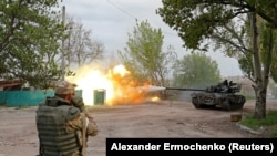 Moscow-backed separatist troops fire from a tank during fighting near the Azovstal steel plant in the southern port city of Mariupol on May 5.