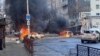 Cars burn on a street after Russian missile strikes on the Ukrainian port city of Kherson on December 24. 