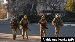 Ukrainian soldiers walk along a street in an area that has seen some the heaviest battles with Russian forces in Bakhmut on December 20.