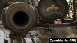 A Ukrainian soldier looks out from a 2S1 Gvozdika self-propelled howitzer on the front line in the Donetsk region on October 10.