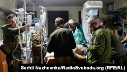 Military medics work to help wounded soldiers at a stabilization point in the eastern city of Bakhmut during recent fighting.