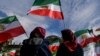  Protesters wave Iranian flags during a rally in front of the Reichstag building in Berlin. During the current wave of unrest, Iranian security forces have taken some 40 foreign nationals into custody, often without revealing any charges.