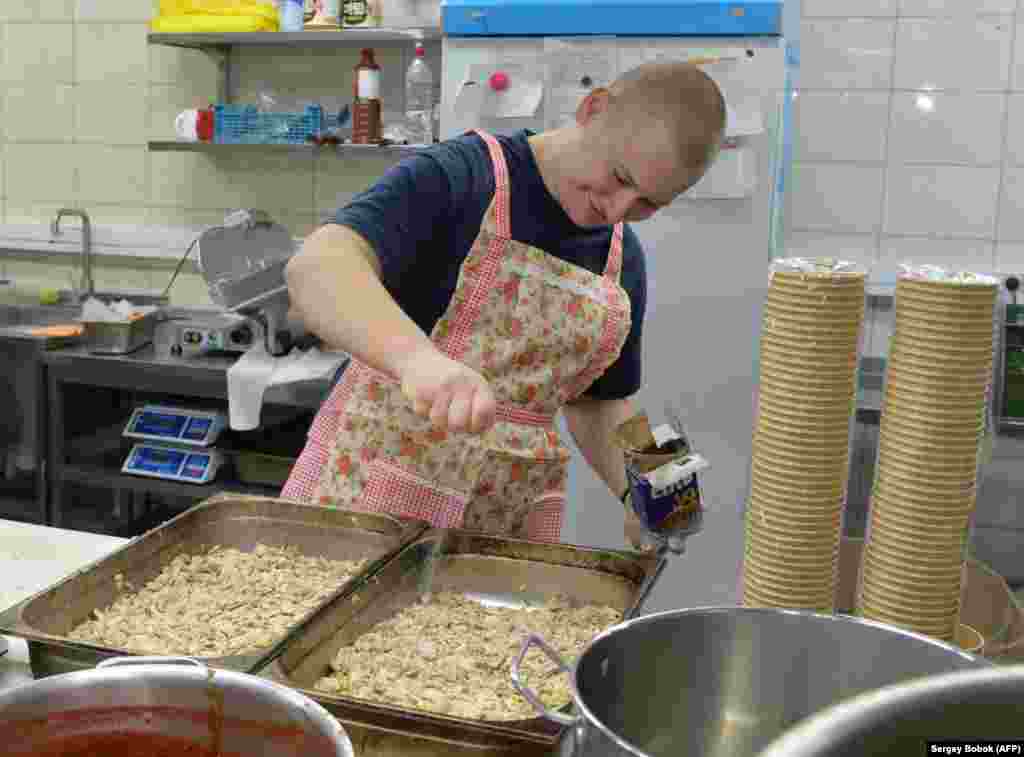 A volunteer prepares meals for soldiers and members of the territorial defense defending the eastern city of Kharkiv in March.