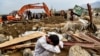 An Afghan villager reacts next to his destroyed house as rescuers search for survivors and bodies after a flash flood hit Parwan Province late last month. 
