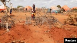 Kafia Noor (5) kod grobova svojih sestara bliznakinja Eble i Abdije koje su umrle od gladi u kampu za interno raseljene u regionu Gedo u Somaliji, 24. maj 2022.