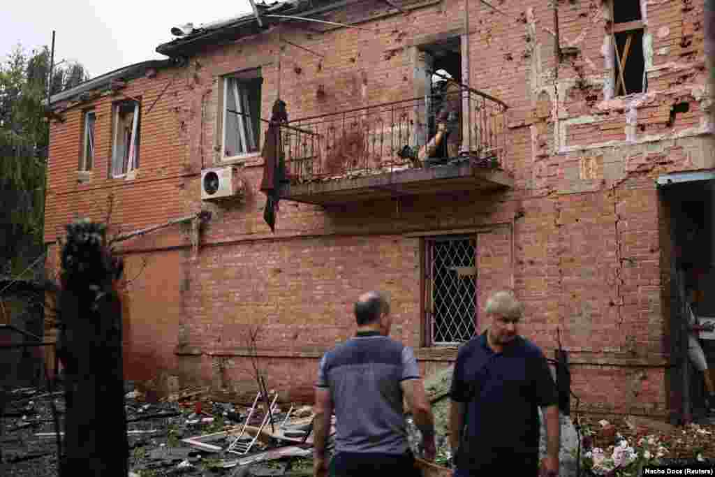 Rescuers extract a body from a residential building damaged by a Russian missile strike in Kharkiv on July 11. Moscow denies targeting civilians, but Russian shelling has left Ukrainian cities, towns, and villages in ruins.