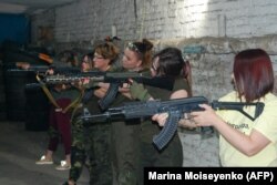 Women learn how to use a Kalashnikov assault rifles in Zaporizhzhya, southeastern Ukraine, at a security training center where a team of experts teaches women to use guns and instructs them in urban combat tactics.