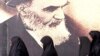Iranian women walk past a poster of the late Supreme Leader Ayatollah Ruhollah Khomeini, who died in 1989. (file photo)