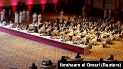 Delegates attend the commencement of talks between the Afghan government and Taliban insurgents in Doha on September 12.