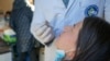 Një qytetare duke u testuar për koronavirus në Institutin Kombëtar të Shëndetësisë Publike në Kosovë - foto arkivi