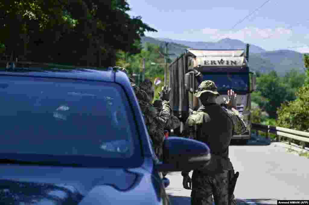 Ushtarët e NATO-s duke përshëndetur me dorë një shofer kamioni në veriun e Kosovës.