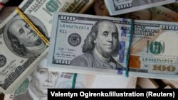 Kartmonedha në dollarë dhe në monedhën kombëtare ukrainse, hrivnia. Fotografi ilustruese. 