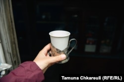 Tea comes in paper cups but is still served in traditional holders.