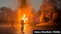 Protestuesit djegin një veturë pranë zyrës së kryetarit të qytetit të Almatit më 5 janar 2022.
