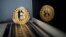 FILE PHOTO: A bitcoin is seen in an illustration picture taken at La Maison du Bitcoin in Paris