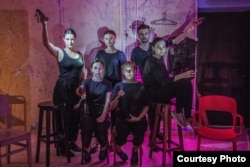 Actors from the theater company Mizh Tryokh Kolon (Between Three Columns) holding flashlights for their performance of Zhadayka (Recall) in Kyiv in September.