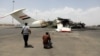 Media photographers take pictures of a destroyed plane at Sanaa International Airport in the aftermath of an Israeli airstrike earlier this month. 