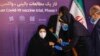 A woman receives an injection during the first trial phase of a locally made Iranian vaccine for COVID-19 in the capital, Tehran, on December 29.