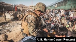 Militari americani la unu din punctele de cotrol, la intrarea în aeroportul internațional „Hamid Karzai” de la Kabul, 26 august 2021. 