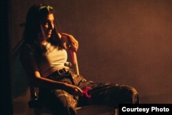 Svitlana Melnyk, co-author, researcher, and actor in Vona Viyna (She Is War), rests with a carrot and vegetable peeler as she prepares food for soldiers during a performance in Odesa in August.
