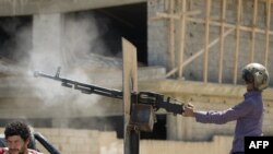Pobunjenik sa kacigom pilota uptavlja mitraljezom montiranim na pick-up kamionu tokom teških sukoba sa provladinim snagama u centru Misurate, 18. april 2011.