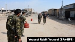 A file photo of fighters from Syrian Democratic Forces (SDF) patrolling in the city of Raqqa, which was once in the hands of Islamic State. 