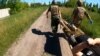 Ukrainian combat medics carry wounded soldier on a stretcher