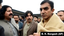 FILE: Leaders of the Pashtun Tahafuz (Protection) Movement or (PTM), Mohsin Dawar, right, and Ali Wazir, left, arrive at National Press Club in Islamabad, for a protest in January.