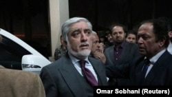 Afghan presidential candidate Abdullah Abdullah leaves a gathering after declaring victory on February 18.