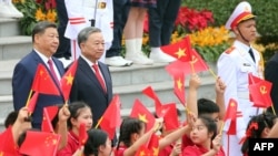 Vietnam's General Secretary of the Communist Party To Lam and Chinese leader Xi Jinping at the Presidential Palace in Hanoi on April 14.
