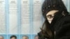 A girl waits for her mother at a polling station in Grozny on 27 November
