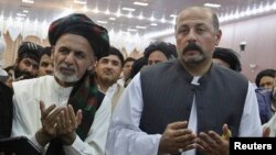 Hashmat Karzai (R) with Afghan presidential candidate Ashraf Ghani during a campaign event in Kandahar on June 6, 2014. 