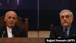 Ghani (left) with his longtime rival, Abdullah Abdullah, at the presidential palace in Kabul in July.