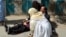 A doctor treats an injured lawyer at the scene of a suicide attack in the southwestern Pakistani city of Quetta. The August 8 attack killed 75 people. Most victims were lawyers.