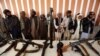 Former Taliban militants surrender arms in the western Afghan city of Herat.