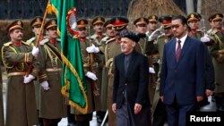 FILE: Afghan President Ashraf Ghani (2nd R) inspects the honor guards during a ceremony to introduce his new cabinet to the parliament in Kabul in January 2015.