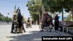 Taliban fighters patrol inside the city of Ghazni, southwest of Kabul, on August 12.