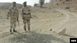 Pakistani paramilitary soldiers guard the site of a landmine blast planted by alleged Baluch nationalists in the Dera Bugti region in 2006.