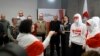 Exiled Belarusian opposition leader Svetlana Tikhanovskaya (3rdR) looks on as she stands next to members of the Belarusian Volny Chor (R) performing during a press conference with freed political prisoners, among them Belsat journalist Iryna Slaunikava (2