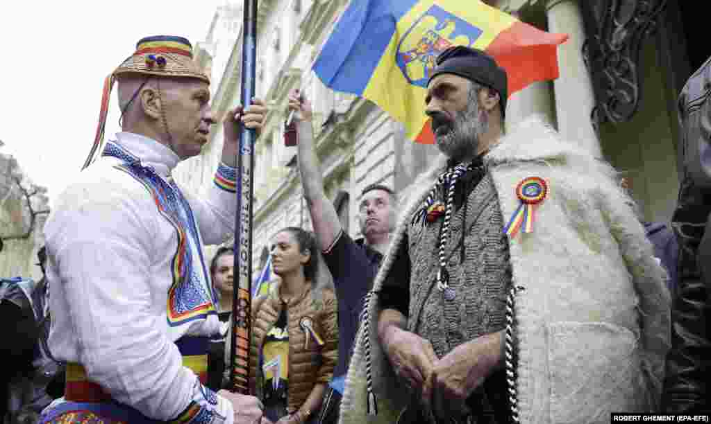 Muškarci obučeni u drevnu dačku odeću (desno) i tradicionalno seljačko odijelo prisustvuju protestu koji su organizovali rumunski ultranacionalisti u Bukureštu, protestujući protiv nedavnog poništenja rezultata prvog kruga predsjedničkih izbora.
