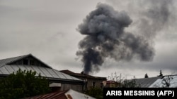 Smoke rises behind houses after shelling in Nagorno-Karabakh. The recent escalation in hostilities in the breakway region has also seen a surge in tweets about the conflict. 