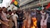 Supporters of Pakistan People's Party (PPP) burn tyres and chant slogans to condemn the arrest of former president Asif Ali Zardari in Karachi, June 10, 2019